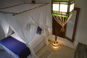 - une chambre avec un lit à baldaquin dans l'établissement Casa Exclusiva na Falésia - Barraca da Maré, Arraial d'Ajuda, à Arraial d'Ajuda