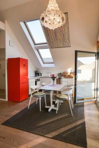Una cocina con una mesa y un refrigerador rojo. en Ostsee - Appartement Nr 91 "Panta Rhei" im Strand Resort, en Heiligenhafen