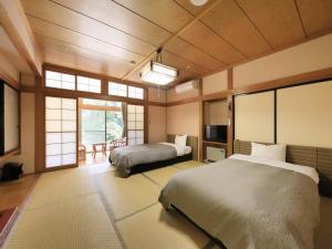 Giường trong phòng chung tại ステイインホテル材木栄屋
