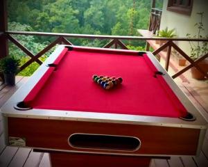 a red pool table with a group of balls on it at Alto de la Castilla in Constanza