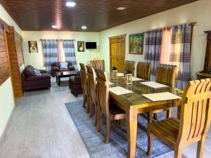 a dining room with a wooden table and chairs at Alto de la Castilla in Constanza