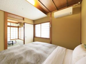 Giường trong phòng chung tại ステイインホテル材木栄屋