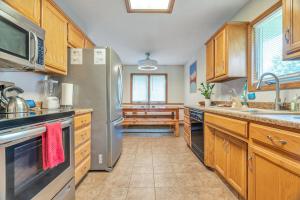 a kitchen with wooden cabinets and a stainless steel refrigerator at Relax at the Summit - 3bd 2b in Springfield