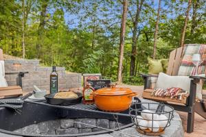 a table with food on top of a grill at Honeybear Hideaways - Luxurious Modern 7BR Cabin with Indoor Pool, Game Room, Hot Tub & Fireplace in Sevierville