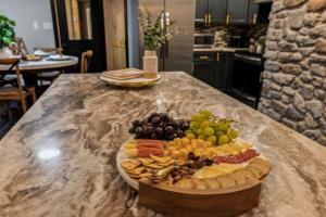 a plate of fruit on a counter in a kitchen at Honeybear Hideaways - Luxurious Modern 7BR Cabin with Indoor Pool, Game Room, Hot Tub & Fireplace in Sevierville