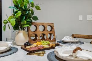 a table with a plate of food on a table at Honeybear Hideaways - Luxurious Modern 7BR Cabin with Indoor Pool, Game Room, Hot Tub & Fireplace in Sevierville
