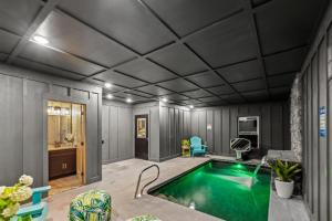 a living room with a swimming pool in a house at Honeybear Hideaways - Luxurious Modern 7BR Cabin with Indoor Pool, Game Room, Hot Tub & Fireplace in Sevierville