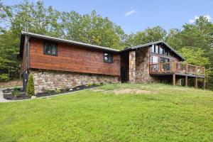 a house with a large yard in front of it at Honeybear Hideaways - Luxurious Modern 7BR Cabin with Indoor Pool, Game Room, Hot Tub & Fireplace in Sevierville