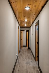 an empty corridor in an office building with wood ceilings at Honeybear Hideaways - Luxurious Modern 7BR Cabin with Indoor Pool, Game Room, Hot Tub & Fireplace in Sevierville