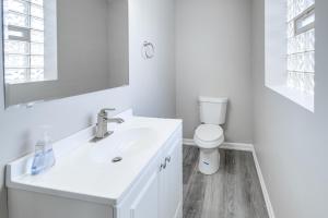a white bathroom with a sink and a toilet at 3 Mi to Cuyahoga Valley NP Fairlawn Family Home! in Fairlawn +20 photos