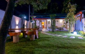 a bench in front of a house at night at New! Mangalam house, Private plunge pool near beach in Trincomalee