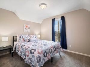 a bedroom with a bed and a window at Large Remodeled 4 Bedroom Only 7 Minutes to Downtown in Cleveland