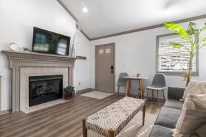 a living room with a fireplace and a table and chairs at Jarrett Farm Resort - Suite 9 in Ramona
