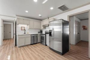 a kitchen with stainless steel appliances and white cabinets at Jarrett Farm Resort - Suite 11 in Ramona