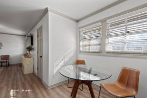 a dining room with a glass table and chairs at Jarrett Farm Resort - Suite 11 in Ramona