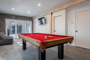 a room with a red pool table in it at ÔShack - spa - billiard in Saint Come