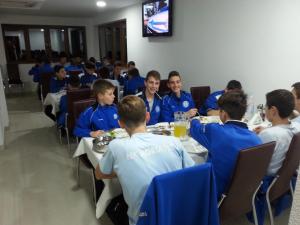 a group of children sitting at tables in a room at Pansion Turudić in Međugorje