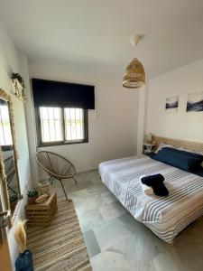 a bedroom with a bed and a chair in it at Apartamento en Barbate in Barbate +19 photos
