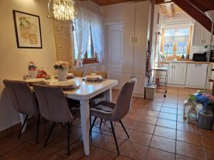 a kitchen and dining room with a table and chairs at Family friendly house with a parking space Varazdin, Zagorje - 22470 in Kućan Marof