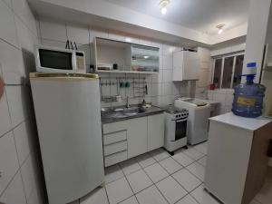 a small kitchen with a sink and a microwave at Apartamento completo,no Janga, perto de Olinda in Paulista