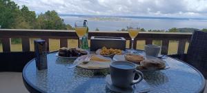 a table with two glasses of wine and food on it at Cabañas Chillwe in Coñao