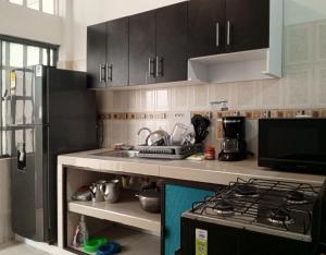 a kitchen with a sink and a stove top oven at Olímpico, Apartamento Familiar. in Villavicencio