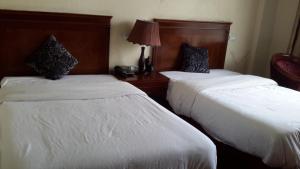 Postel nebo postele na pokoji v ubytování FT Hotel