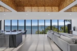 a living room with a large couch and a table at Stylish Home with Outdoor Area & Spectacular Views in Penna