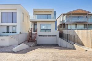 a house with a driveway with a garage at 106 Surfers Parade Middleton - Linen Included in Middleton