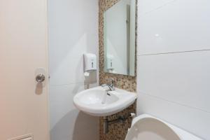 a bathroom with a sink and a mirror at Hotel Sogo Santa Mesa in Manila +18 photos