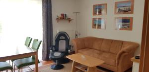 a living room with a couch and a chair at Ostseeglück App9 in Zingst