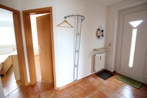a room with a hallway with a door and a tile floor at Ostseeglück App9 in Zingst