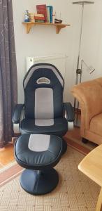 a chair sitting in a living room next to a couch at Ostseeglück App9 in Zingst