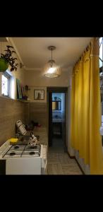 a kitchen with a stove and a yellow curtain at Dreams in La Plata