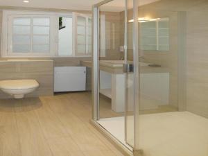 a bathroom with a toilet and a glass shower at Holiday Home in Carnac near Sandy Beach in Carnac +32 photos