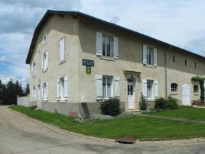 a large brick building with white windows on a street at House near Lac de Madine with Historic Charm in Lahayville