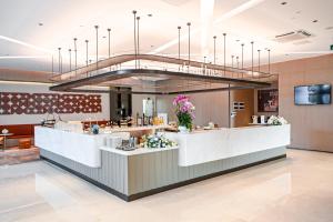 a restaurant with a large chandelier above a counter at Citadines Science City Guangzhou-Shuttle bus to Canton Fair Complex during Canton Fair period in Guangzhou
