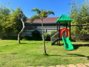a playground with a slide in a yard at Comfort Zone in Dao