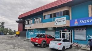 a red truck parked in front of a building at El Paso de Almirante in Almirante