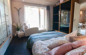 a bedroom with a large bed and a window at Cozy Home In Gotlands Tofta With Wifi in Gnisvärd