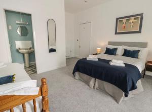 1 dormitorio con 1 cama grande y lavamanos en Sandpiper Apartment, en Barmouth