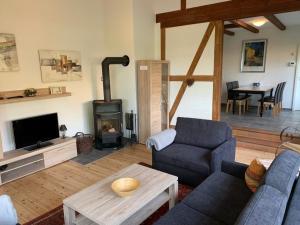 a living room with a couch and a fireplace at Haus Lucie am Jabeler See in Jabel