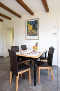 a dining room with a wooden table and chairs at Haus Lucie am Jabeler See in Jabel