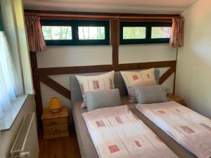 two beds in a small room with two windows at Haus Lucie am Jabeler See in Jabel +4 photos