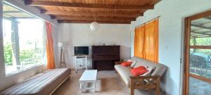 a living room with a couch and a table at FUJI - Casas para relajar in Villa de Las Rosas