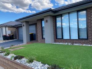 a house with a lawn in front of it at Serenity in Melton South