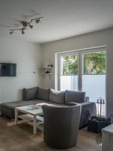 a living room with a couch and a table at Ferienhaus Ruheoase im Müritz Seepark in Röbel