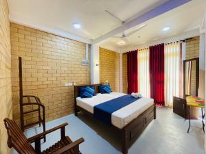 a bedroom with a bed and a table and chairs at CDR Eco Home in Weligama