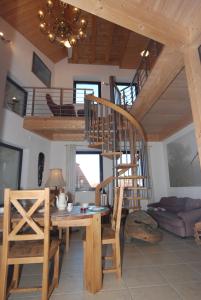 a living room with a spiral staircase and a table and chair at Ferienwohnung Muschel in Heiligenhafen