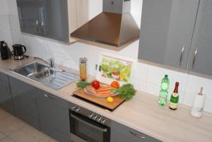 a kitchen counter with a cutting board with vegetables on it at Ferienwohnung Muschel in Heiligenhafen